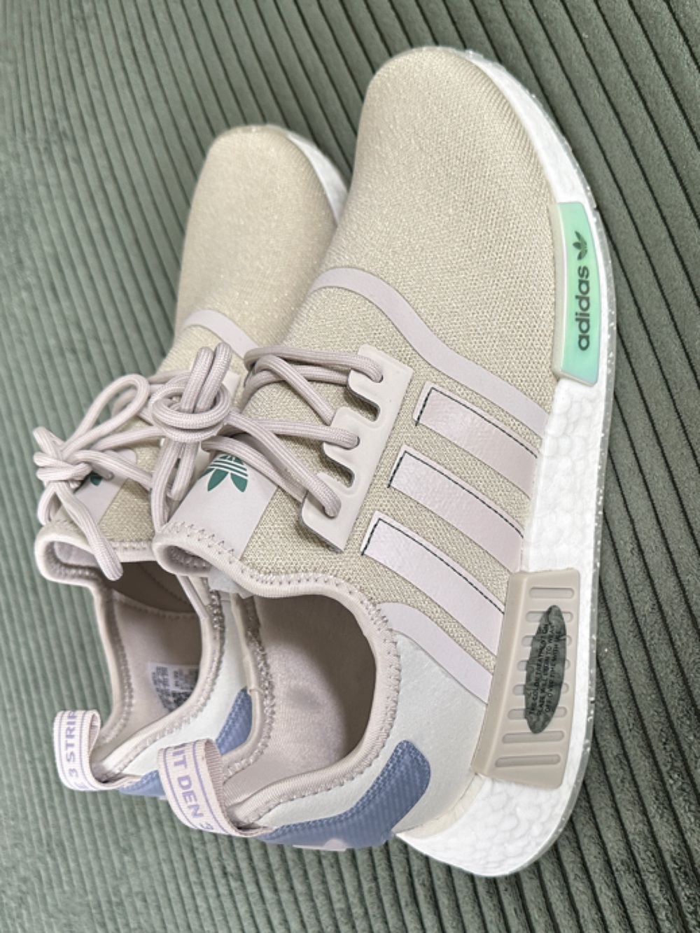 Adidas NMD R1 running shoe in “bliss” (iridescent accents)